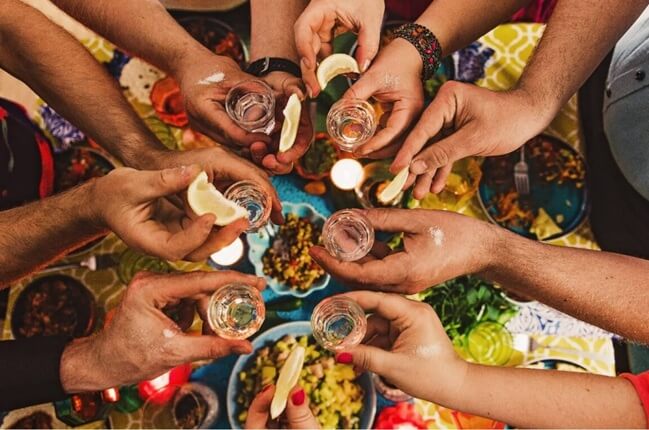 Friends sharing tequila at an at home tequila party event